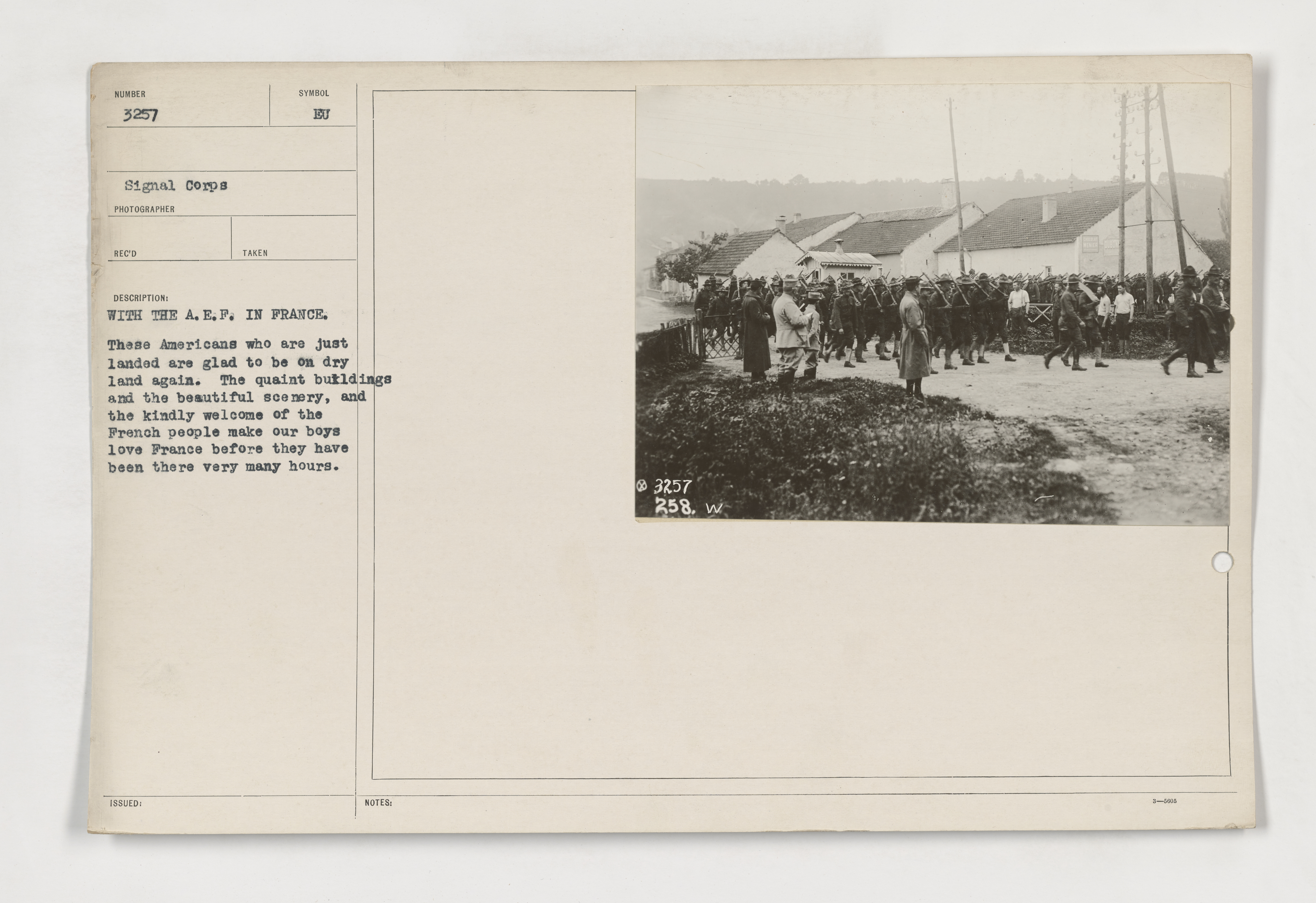 111-SC-3257 - With the A.E.F. in France. These Americans who are just landed are glad to be on dry land again. The quaint buildings and the beautiful scenery, and the kindly welcome of the French people make our boys love France before they have been thee very many hours.