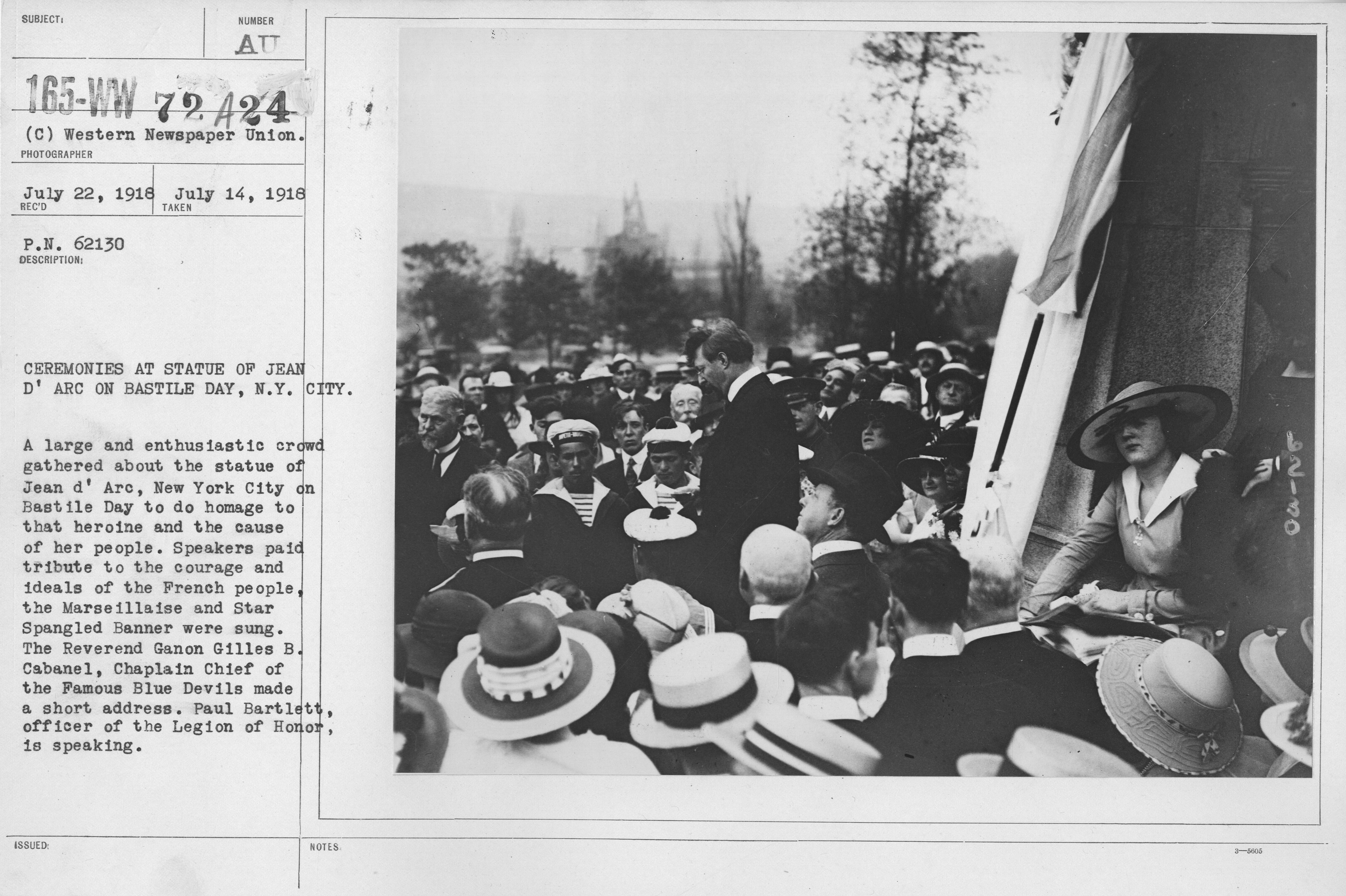 Ceremonies - Bastille Day, 1918 - Ceremonies at Statue of Jean D'Arc on Bastille Day, N.Y. City. A large and enthusiastic crowd gathered about the statue of Jean d'Arc, New York City on Bastille Day to do homage to that heroine and the cause of her people. Speakers paid tribute to the courage and ideals of the French people, the Marseillaise and Star Spangled Banner were sung. The Reverand Ganon Gilles B. Cabanel, Chaplain Chief of the Famous Blue Devils made a short address. Paul Bartlett, officer of the Legion of Honor, is speaking