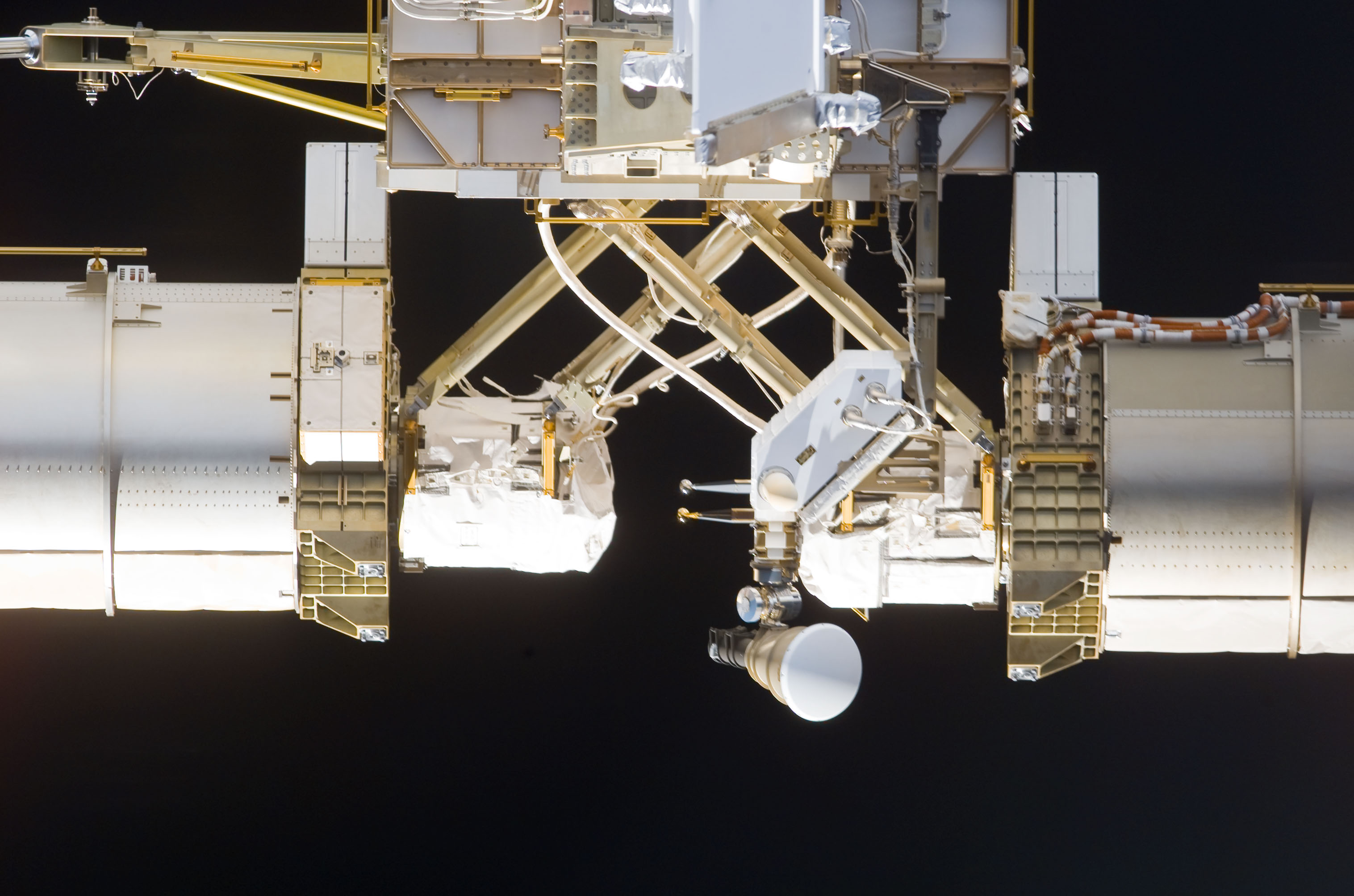 S113E05425 - STS-113 - Mast canisters for the PV Arrays taken during flyaround following STS-113 undocking