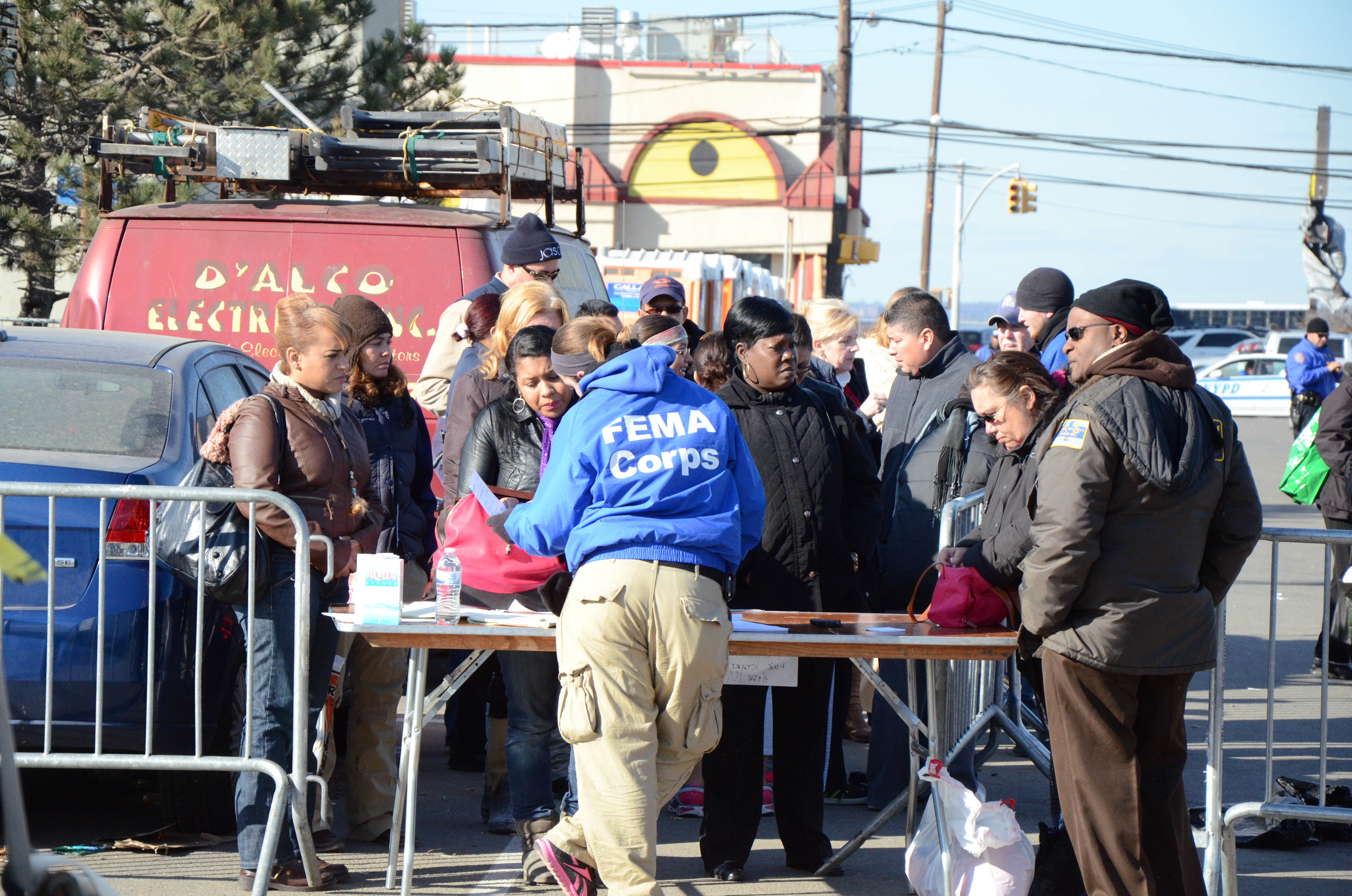 Rockaway, N.Y., Nov. 5, 2012 -- FEMA Corps member Casey Stewart checks in survivors of Hurricane Sandy to the Rockaway Disaster Recovery Center as well as answers questions about assistance available through FEMA. FEMA is working with state and local officials to assist residents who were affected by Hurricane Sandy. Photo by Sean Kerr/FEMA