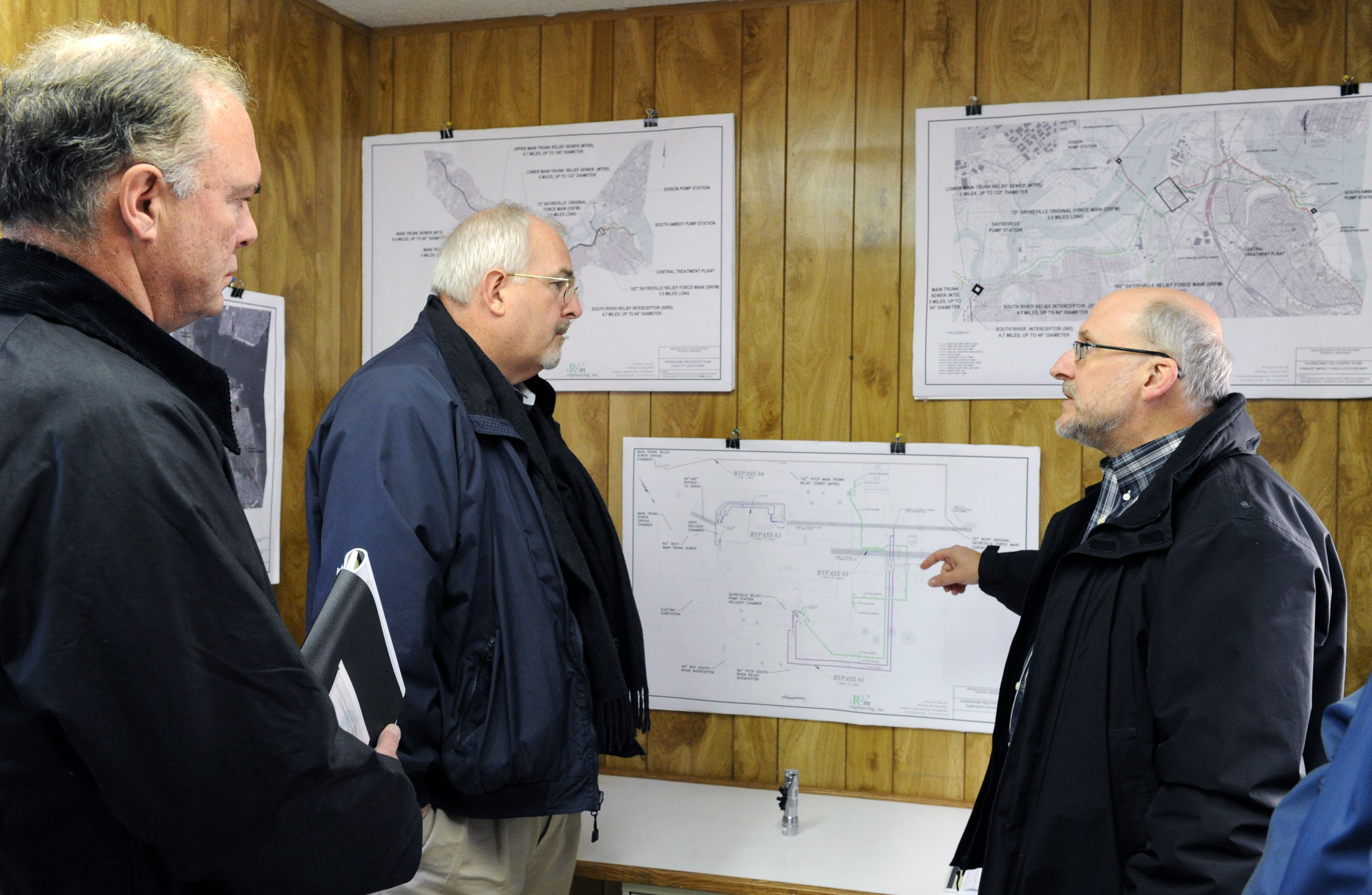 Sayerville, N.J., Nov. 28, 2012 -- FEMA Administrator Craig Fugate, center, and Commissioner of NJ Environmental Protection Bob Martin, get a briefing on the local Water Pumping Station that was impacted during Hurricane Sandy, by Water and Wastewater Engineer Michael Samuel. The station was underwater during the storm. Jocelyn Augustino/FEMA