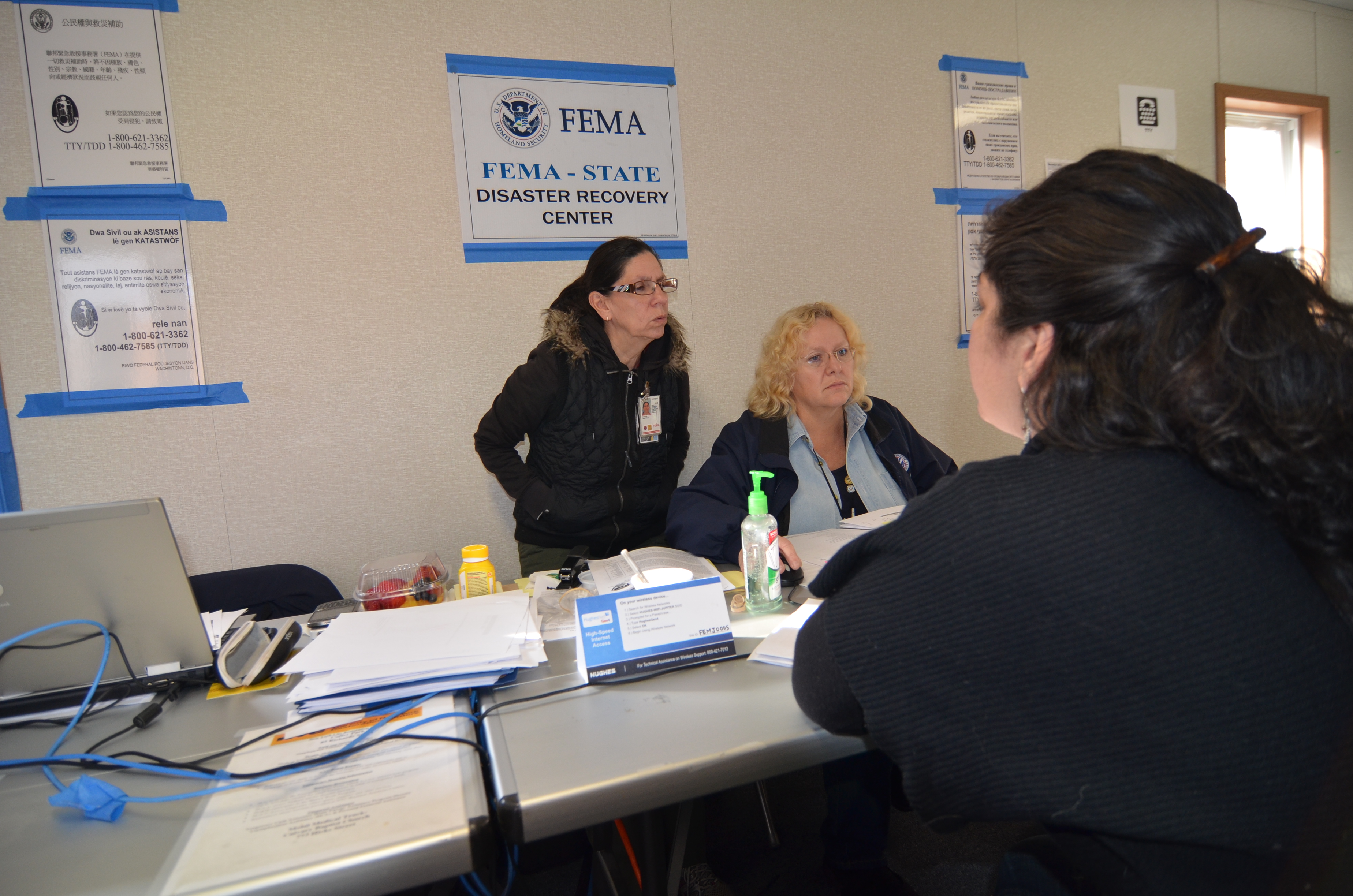 New York City, N.Y., Dec. 11, 2012 -- Residents of the Borough of Brooklyn in New York City apply for assistance at FEMA's Red Hook Disaster Recovery Center. Hurricane Sandy displaced many citizens of the city of New York, and FEMA provides cash and other assistance to these survivors. Walt Jennings/FEMA