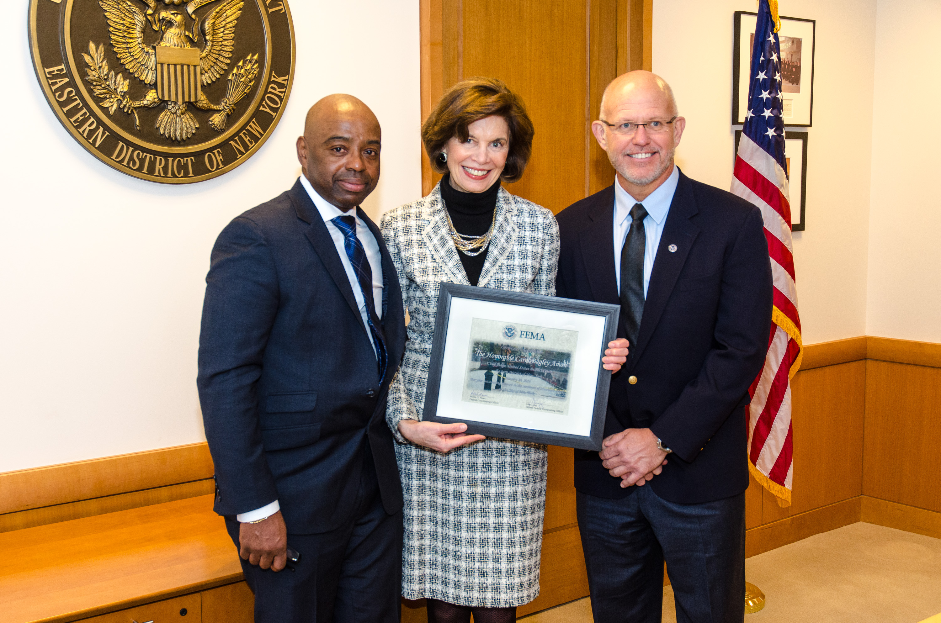 Brooklyn, N.Y., Jan. 24, 2014 -- FEMA Federal Coordinating Officer (FCO) Willie Nunn (left) and Deputy FCO John Long present Chief Judge Carol Bagley Amon, with a certificate of appreciation for allowing FEMA to use space in the courthouse for their Branch II office during the response to Hurricane Sandy. K.C.Wilsey/FEMA